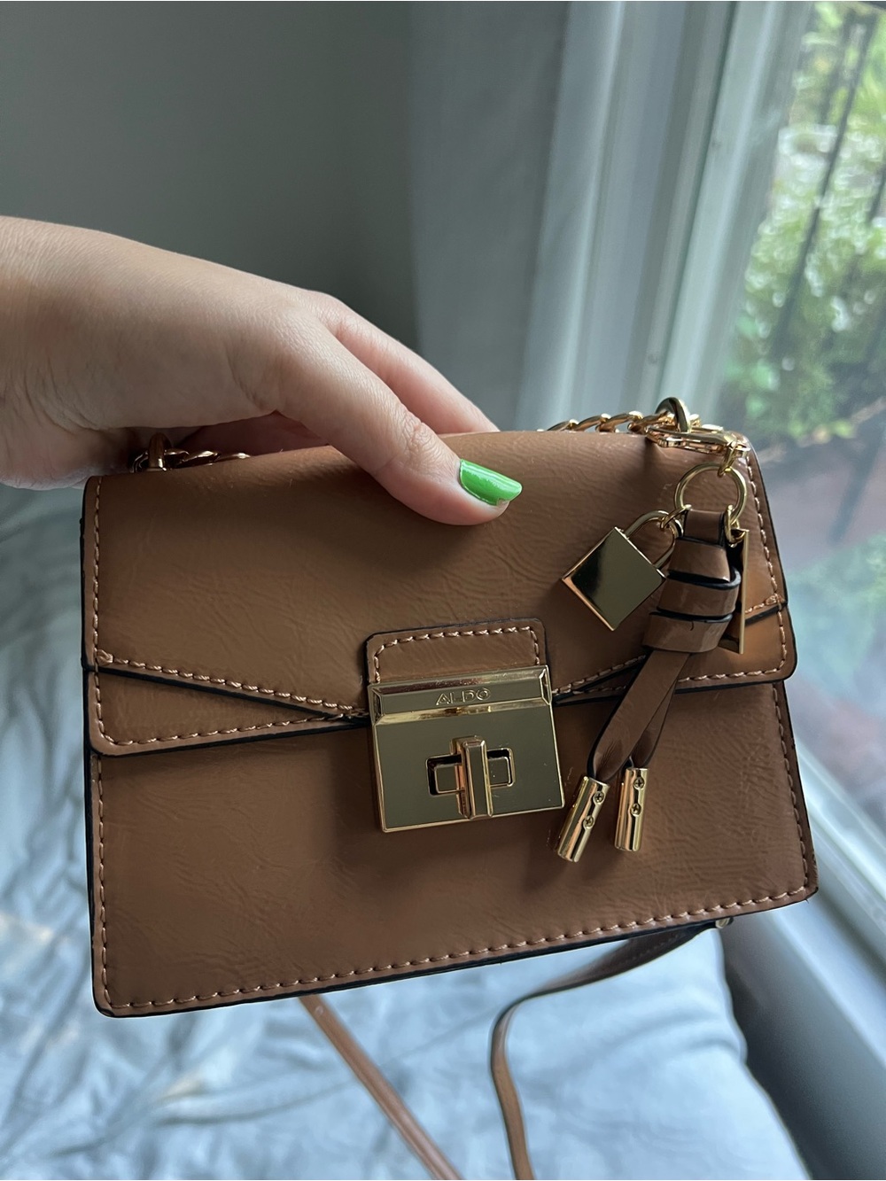 Aldo Brown Crossbody Bag with Gold Hardware and Tassel Charm